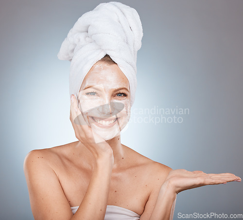 Image of Woman portrait and face mask after a shower for skincare, beauty and health on a grey studio background. Skin care, mask for glowing skin on a female for cosmetic and dermatology wellness