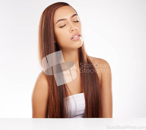 Image of Beauty, hair care and woman in a studio with a healthy, wellness and natural luxury routine. Model from Mexico with keratin treatment, brazilian or conditioner for shiny hairstyle by white background