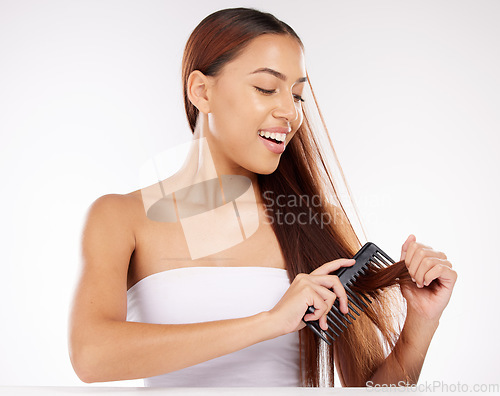 Image of Hair, beauty and woman in studio for comb, brushing and styling against a white background mockup. Hair care, wellness and girl model combing long hair for texture, grooming and cleaning with mock up