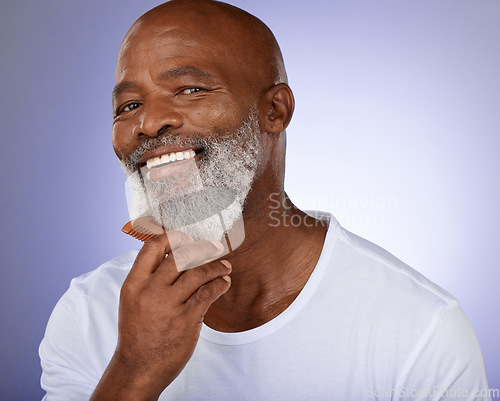 Image of Senior, black man and grooming beard portrait or cleaning face for skincare wellness and beauty hygiene products. Elderly, male model and natural facial hair with comb in purple background studio