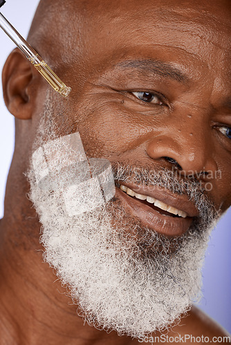 Image of Skincare, oil and happy, senior and man in studio for facial, wellness and serum product, wrinkles and hydration closeup. Zoom, face and skin, hyaluronic acid or retinol for elderly man beauty