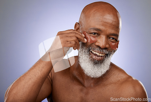 Image of Face, senior and black man with eye patches in studio on a purple background. Portrait, skincare and retired elderly male model from Nigeria with anti aging product, facial pads or mask for wellness.