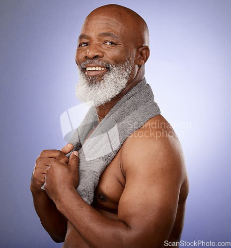 Image of African man, towel and portrait in studio for shower, wellness or skincare by purple backdrop. Happy black man, elderly model or cleaning for beauty, health or aesthetic by lavender studio background