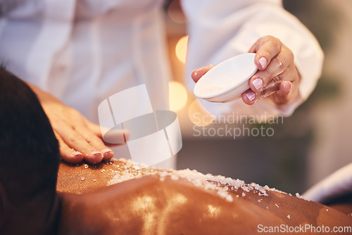 Image of Massage, spa and scrub on a back for exfoliate treatment for soft, healthy and smooth skin. Luxury, wellness and therapist doing salt body exfoliation detox for health, hygiene and body care at salon