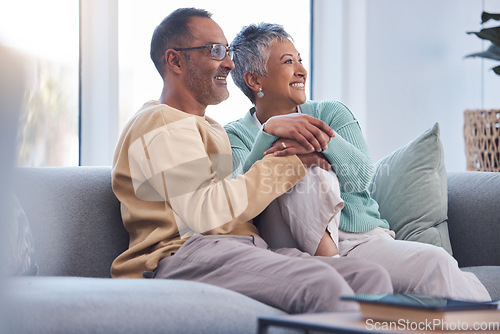 Image of Elderly couple, relax and smile watching tv, movie or streaming on sofa together at home. Senior man and woman relaxing on living room couch enjoying online shows, media or entertainment indoors