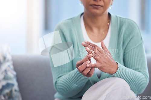 Image of Doubt, stress and hands taking off ring for a divorce after marriage conflict, toxic relationship or cheating. Anxiety, mental health or sad senior woman removing her engagement ring after fighting