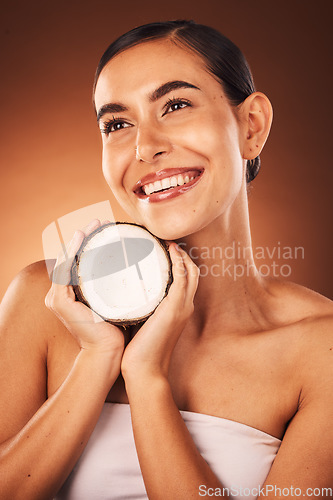 Image of Beauty, coconut and skincare, woman with natural and diy facial product for face, body and skin against studio background. Fruit, detox and healthy cosmetic with wellness and sustainable cosmetics.