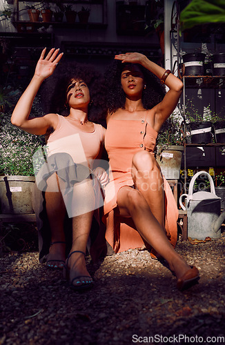 Image of Hands, sunlight and shade with black woman friends blocking the sun while sitting together at a plant nursery. Spring, gardening and growth with a female and friend outdoor at a flower shop