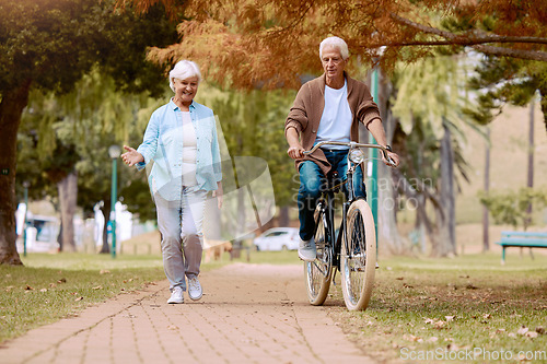 Image of Senior couple, walking and bike at park, talking and bonding together mock up. Love, retirement and elderly man cycling on bicycle with happy woman speaking outdoors for exercise, health and wellness