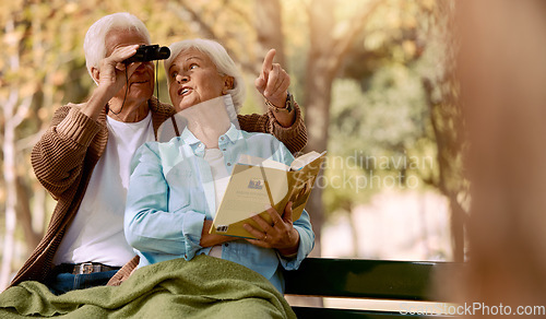 Image of Happy senior couple bird watching in park for relax bonding time together, freedom and retirement peace on outdoor bench. Elderly marriage love, binoculars and book reading woman with man pointing