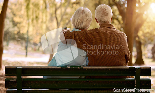 Image of Love, hug and old couple in a park on a bench for a calm, peaceful or romantic summer marriage anniversary date. Nature, romance or back view of old woman and elderly partner in a relaxing embrace