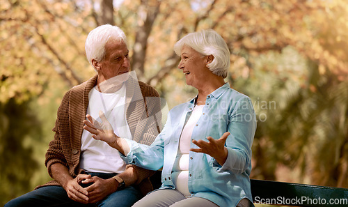 Image of Nature, park and retirement with a senior couple sitting together on a wooden bench outdoor in a garden. Spring, love and summer with a mature man and woman bonding outside in the countryside