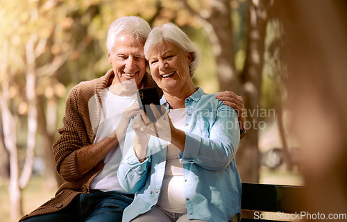 Image of Relax, happy and phone with old couple in park for video call, social media and communication. Smile, health and internet with man and woman on bench in nature for retirement, 5g and technology