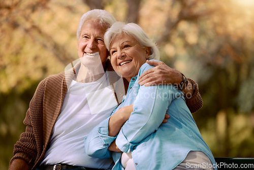 Image of Elderly, couple hug in the park with love and happy in retirement, outdoor in nature, calm and peace with view. Senior man with woman, smile and support, embrace and bonding in Boston public garden.