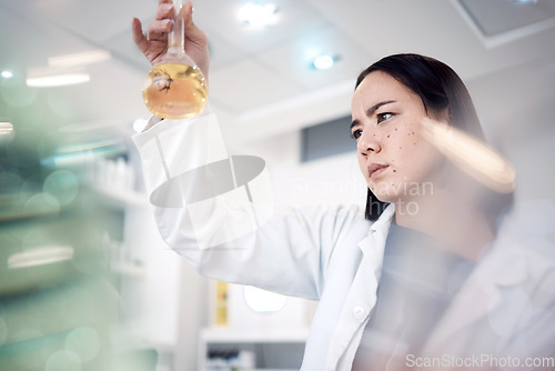 Image of Scientist, medical research and thinking while holding chemical in beaker for analytics, solution and virus test in science laboratory. Asian woman doctor with medicine for healthcare and chemistry