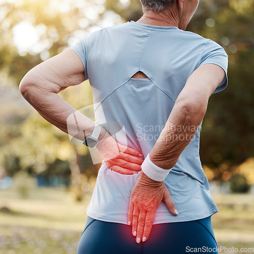 Image of Senior woman with back pain, injury or accident while running at outdoor park for cardio workout. Nature, emergency and elderly female runner with spine inflammation, injured muscle or sprain joint.