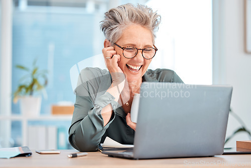 Image of Laptop, coffee and senior business woman laughing at an email in her office at work for fun or humor. Computer, tea and comic with a mature female employee working on a report or project and joking