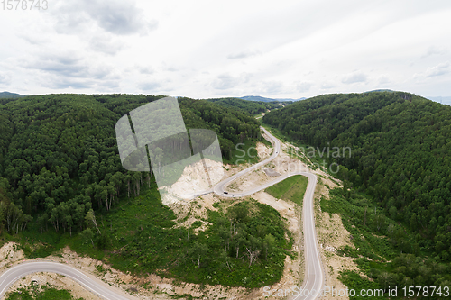 Image of Aerial top vew of winding road in the mountains