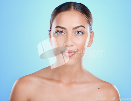 Image of Beauty, face and skin with woman in makeup portrait, skincare, facial and treatment for wellness with blue studio background. Natural cosmetics, clean look cosmetic and glow with dermatology mockup.