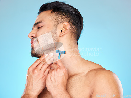 Image of Man, shaving beard and facial skincare cleaning for beauty wellness, morning grooming or self care in studio. Face cleaning, cosmetics dermatology care and shave with razor for self care hygiene