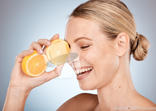 Image of Skincare, beauty and woman with orange in studio for spa wellness, dermatology and facial treatment. Vitamin c, cosmetics and happy girl with fruit for natural, healthy and organic beauty products