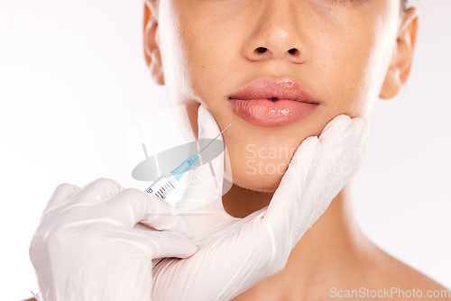 Image of Doctor hand, botox and woman with collagen, needle and face in studio background. Plastic surgery, lip filler and cosmetic lip injection for youth for skincare, natural look and medical expert