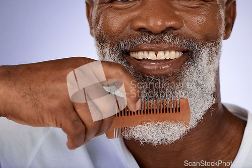 Image of Senior man, face and beard comb in studio isolated on a purple background. Hair care, smile and wellness of happy elderly black man with grooming product for facial hair wellness, health and hygiene.