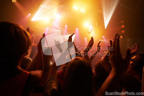 Image of Music rock festival, concert or performance event with audience, crowd or people hands dancing with fans, youth and friends. Group of people at a techno, disco rave or night party club in celebration