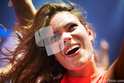 Image of Dance, music and happy with woman at concert for party, nightclub and festival dj event. Disco, rock and freedom with girl dancing in crowd of fans for celebration, energy and techno performance