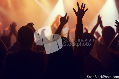Image of Music, lights and hands of crowd at concert for party, disco and live band performance. Dance, nightclub and silhouette of audience listening to artist on stage at festival for energy, rave and event