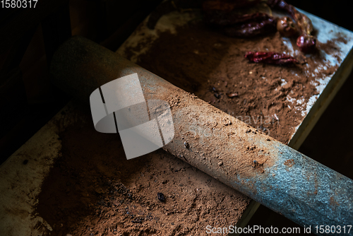 Image of Grinding cacao beans with chili peppers