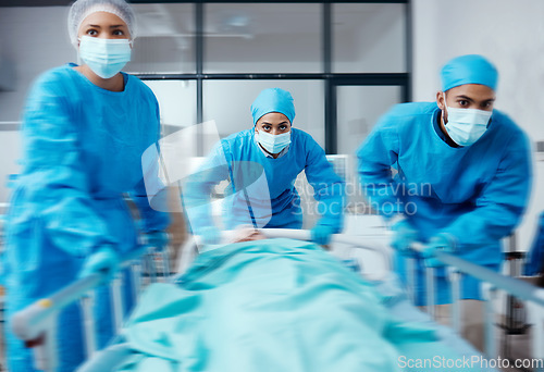 Image of Surgery team, bed and rush in hospital, healthcare or patient emergency. Busy, medical staff or doctors with sick person, mask or nurses ready for procedure, health and wellness for treatment or cure