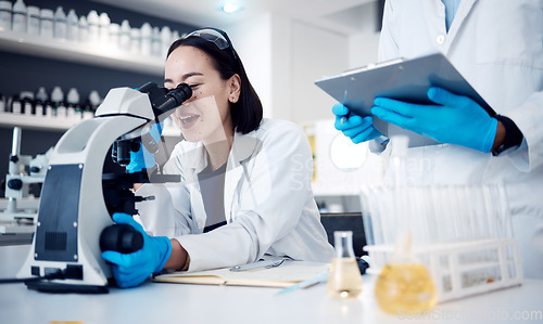 Image of Microscope, scientist and woman with worker, research and medical cure in laboratory. Clipboard, researchers and employees analyzing results, innovation or check sample data for collaboration or talk