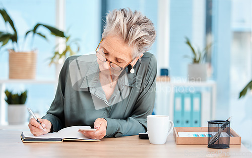 Image of Writing, notebook and schedule with a woman ceo, manager or boss checking her diary for an appointment. Calendar, coffee and notes with a senior female employee using a pen to write in her planner