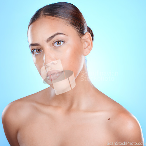 Image of Face, skincare and woman for beauty portrait in studio, cosmetics makeup and luxury wellness. Model, spa facial cleaning and natural skin glow or relax self care dermatology in blue background