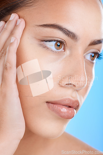Image of Face, beauty and skincare with a model black woman in studio closeup on a blue background for wellness. Botox, microblading and cosmetics with an attractive young female inside for luxury treatment