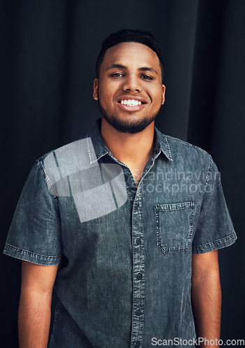 Image of Happy portrait, pride and black man in studio for happiness, posing and fashion style against dark black background. Smile, denim and face of an African model with stylish clothes on dark background