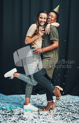 Image of Friends, portrait and hug at New Years eve party with fun, happy women celebrating together. Social, embrace and partying ladies celebrate nightlife with confetti and alchohol drinks on a background