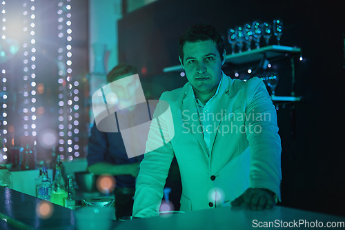 Image of Club, drink and portrait of a bartender working at a party, happy hour and night club event. Lens flare, alcohol server and barman at a dark nightclub for drinks, work and entertainment lifestyle
