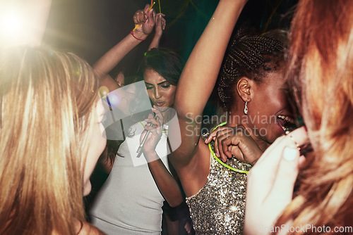 Image of Party women and dance at nightclub rave with glow sticks for cheerful fun, youth and celebration. Interracial, event and happy people dancing together in music club with energetic movement.