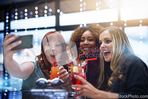 Image of Women, friends and phone selfie at club with drinks, having fun or bonding. Night, celebration and group of girls taking a photo on mobile smartphone for happy memory, social media or profile picture