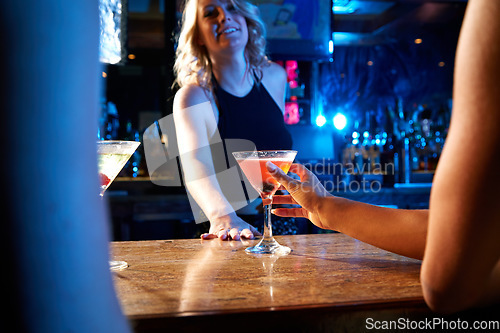 Image of Bartender, nightclub and cocktail drink with mixologist worker at counter serving alcohol at a restaurant, bar or new years party. Hand of woman on glass for drinking, celebration and service