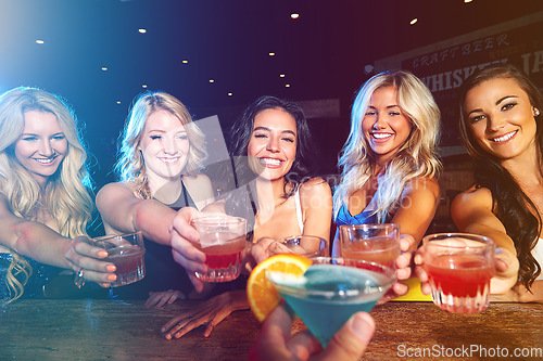 Image of Cocktails, happy hour and friends at club with a toast to celebrate, new years social and drinks during a girls night. Party, alcohol and group of women with a cheers during a celebration at an event