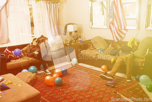 Image of Party, drunk and hangover with a man friends sleeping on a sofa in the living room of a home after a celebration. Birthday, social and alcohol with a male bachelor and friend passed out from drinking