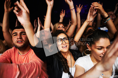 Image of Crowd, concert and people in stadium for music, rock or event with community, energy or hands in air. Group, fans and party for music festival, dance or friends together in arena in night in New York