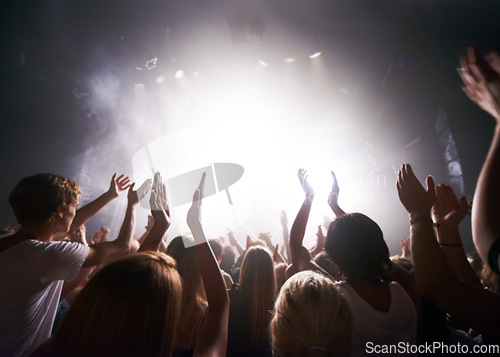 Image of Concert, live music and people dancing at an event, party or nightclub with energy, freedom and fun. Band, musician or dj entertainment playing at music festival or rave at indoor venue with a crowd.