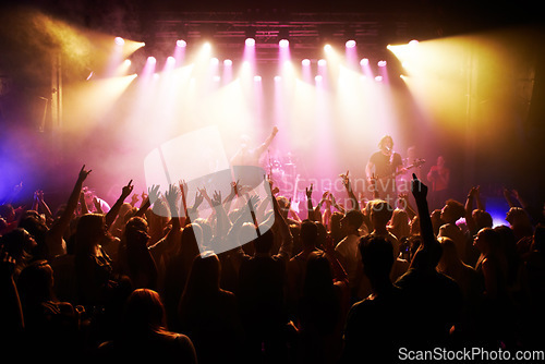 Image of Festival, music and concert with energy of crowd cheering for live rock band on stage. Event, fans and happy people cheer for energetic performance at music festival in Los Angeles, USA.