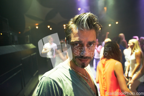 Image of Concert, punk rock man and live band performance at an music festival, event or social party with crowd, fans or people at stage performance. Portrait of a male at club, nightclub or celebration show