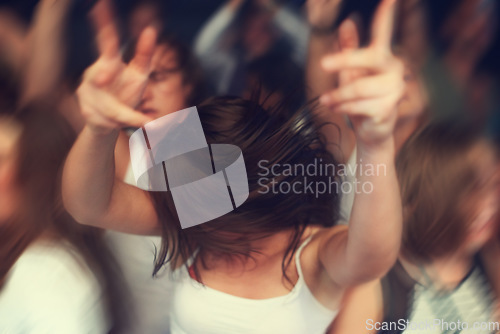 Image of Dance, motion blur and music festival with a woman moving with rhythm in a crowd at a concert or show. Party, freedom and energy with a young female dancing at a disco or celebration event