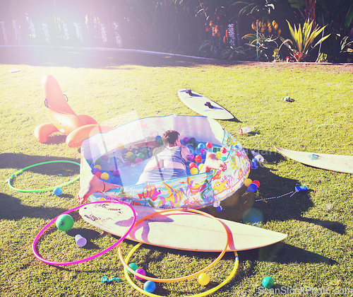 Image of Man, backyard and passed out on grass, drinking and party in summer at with butt open in kids pool. Drunk person, sleeping and lawn with toys, sunshine or hangover on vacation, holiday or celebration